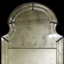 Antique mirror reproduction with polished grooves.